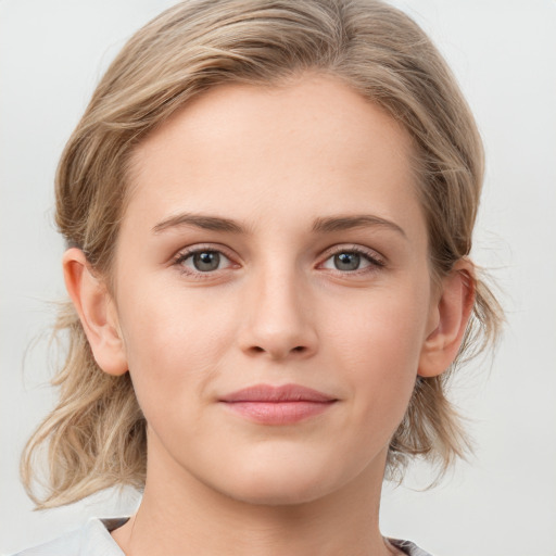 Joyful white young-adult female with medium  brown hair and blue eyes