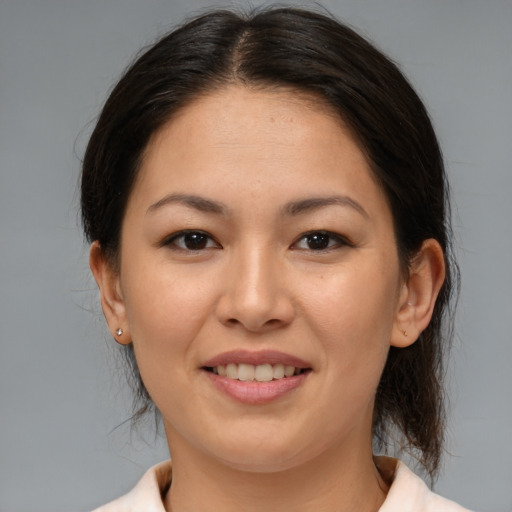 Joyful asian young-adult female with medium  brown hair and brown eyes