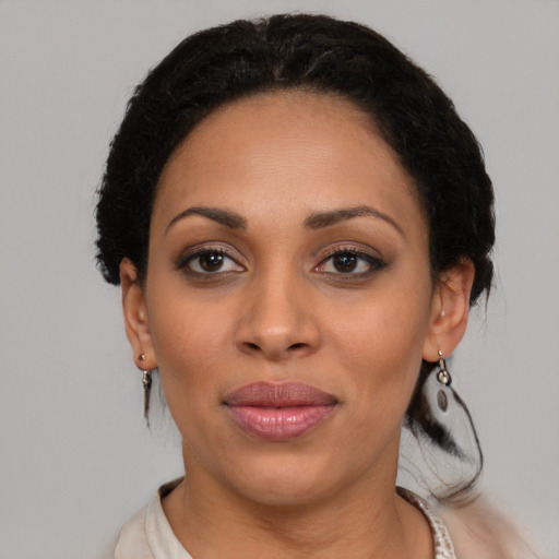 Joyful black young-adult female with medium  black hair and brown eyes