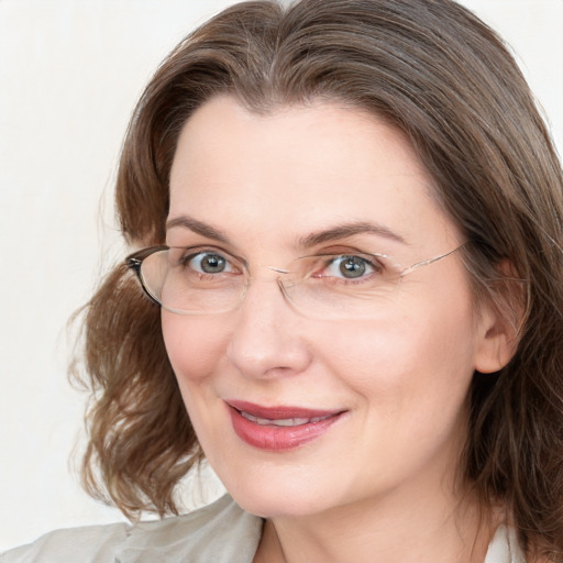 Joyful white adult female with medium  brown hair and blue eyes