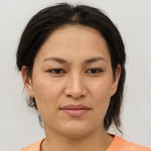 Joyful asian adult female with medium  brown hair and brown eyes