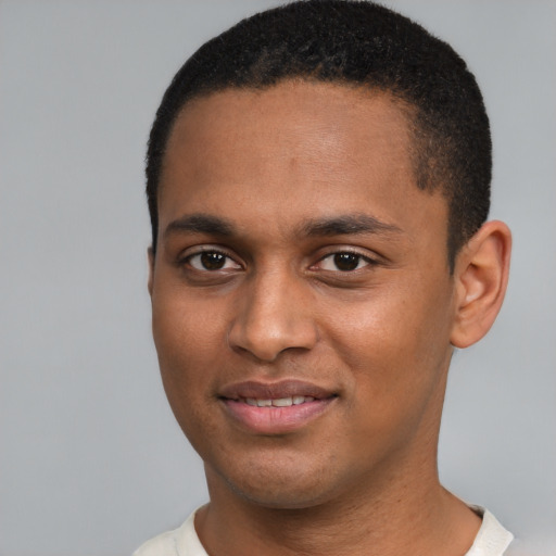 Joyful black young-adult male with short  black hair and brown eyes