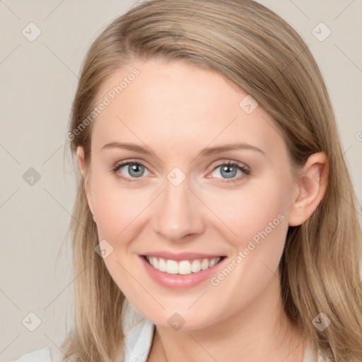 Joyful white young-adult female with long  brown hair and blue eyes