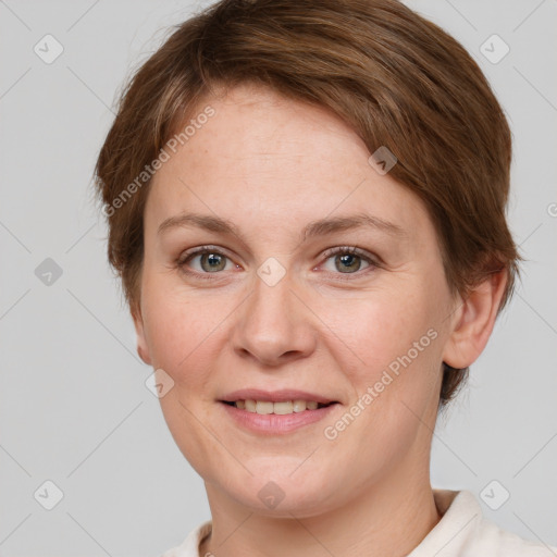 Joyful white young-adult female with short  brown hair and grey eyes