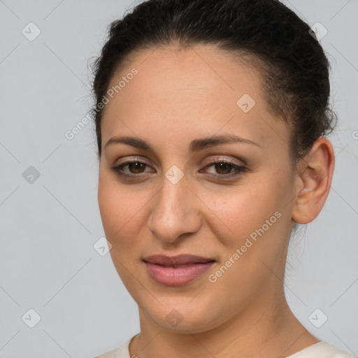 Joyful latino young-adult female with short  brown hair and brown eyes