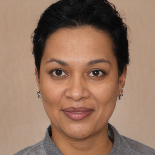 Joyful latino young-adult female with short  black hair and brown eyes
