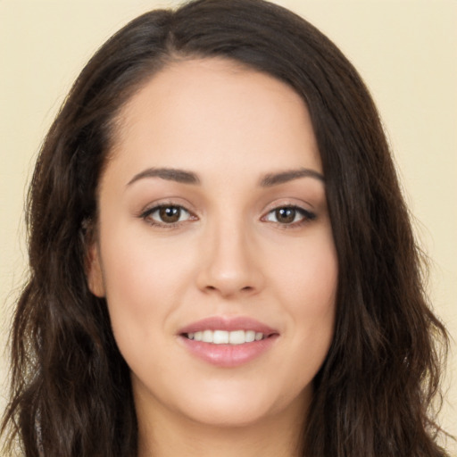 Joyful white young-adult female with long  brown hair and brown eyes