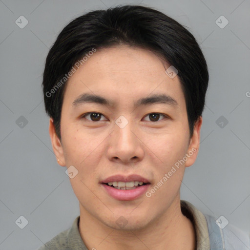 Joyful asian young-adult male with short  brown hair and brown eyes