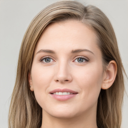 Joyful white young-adult female with long  brown hair and grey eyes