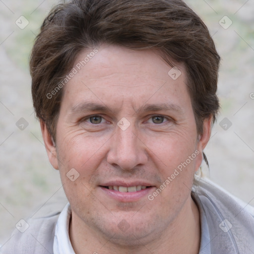 Joyful white adult male with short  brown hair and grey eyes