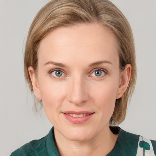 Joyful white young-adult female with medium  brown hair and blue eyes