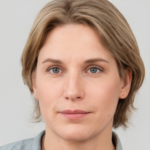 Joyful white young-adult female with medium  brown hair and blue eyes