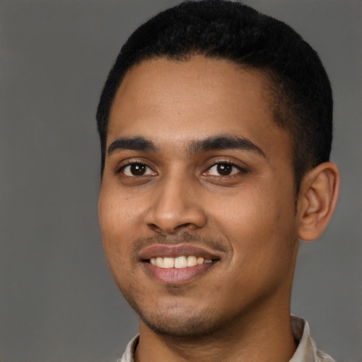 Joyful black young-adult male with short  black hair and brown eyes