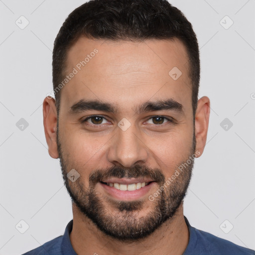 Joyful white young-adult male with short  black hair and brown eyes
