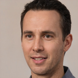 Joyful white adult male with short  brown hair and brown eyes