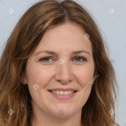 Joyful white adult female with long  brown hair and brown eyes