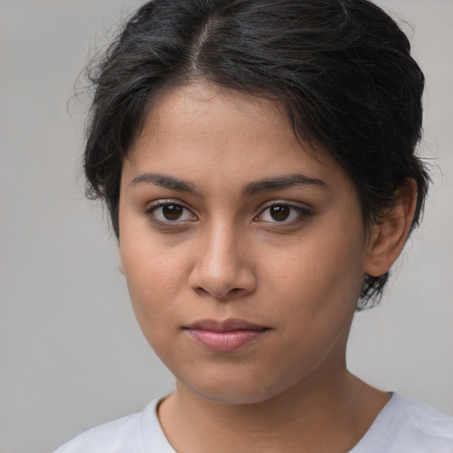 Joyful latino young-adult female with medium  brown hair and brown eyes