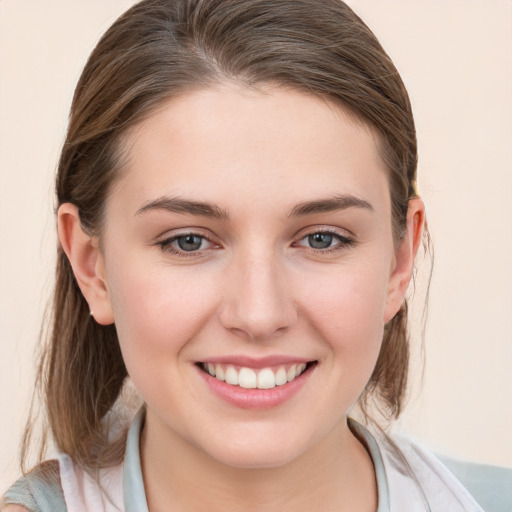 Joyful white young-adult female with medium  brown hair and blue eyes