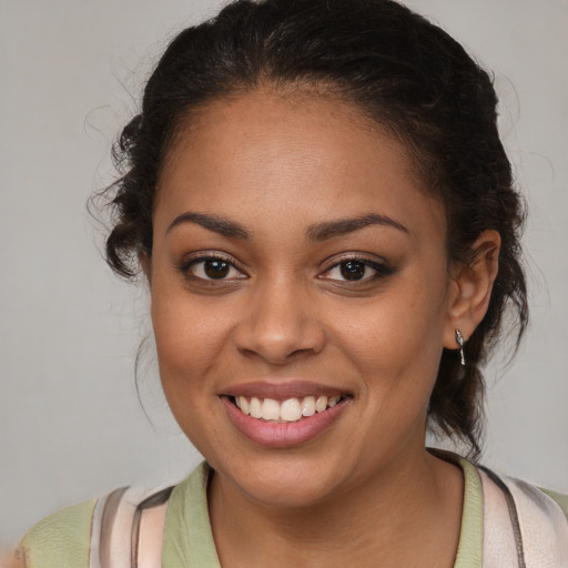 Joyful latino young-adult female with medium  brown hair and brown eyes