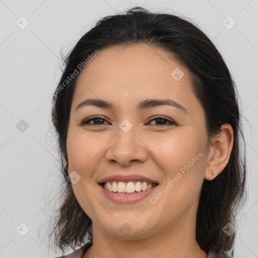 Joyful latino young-adult female with medium  brown hair and brown eyes