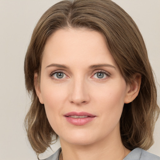 Joyful white young-adult female with medium  brown hair and green eyes