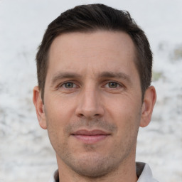 Joyful white adult male with short  brown hair and brown eyes