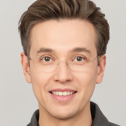 Joyful white adult male with short  brown hair and grey eyes