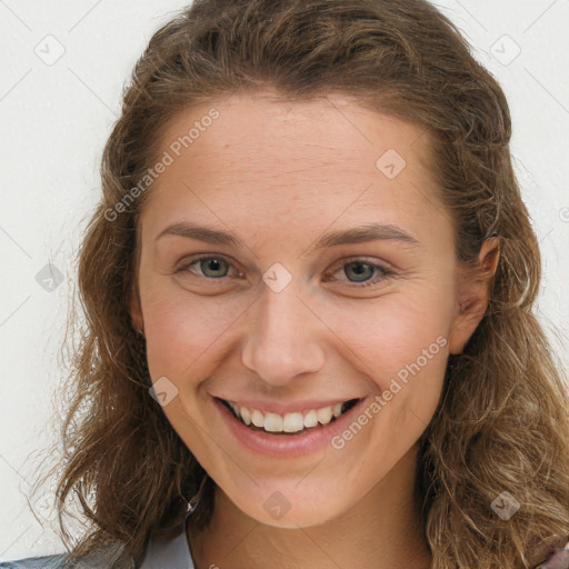 Joyful white young-adult female with long  brown hair and green eyes