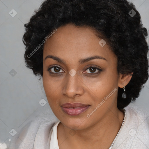 Joyful black young-adult female with short  black hair and brown eyes