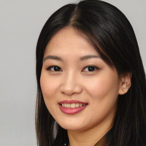 Joyful asian young-adult female with long  black hair and brown eyes