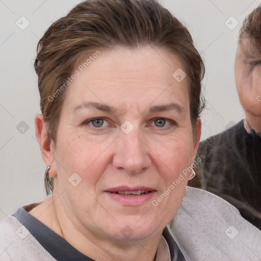 Joyful white adult female with short  brown hair and blue eyes