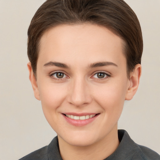 Joyful white young-adult female with short  brown hair and brown eyes