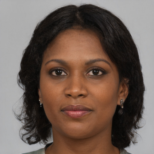 Joyful black young-adult female with medium  brown hair and brown eyes