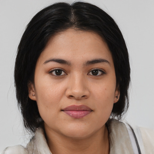 Joyful latino young-adult female with medium  brown hair and brown eyes