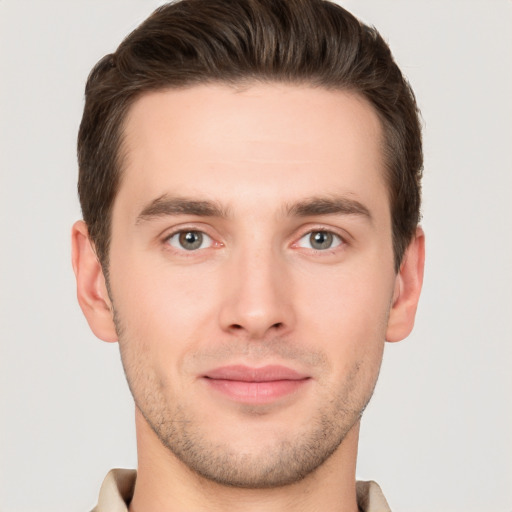 Joyful white young-adult male with short  brown hair and brown eyes