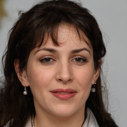 Joyful white adult female with medium  brown hair and brown eyes