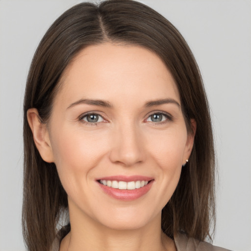 Joyful white young-adult female with medium  brown hair and brown eyes