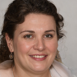 Joyful white adult female with medium  brown hair and brown eyes