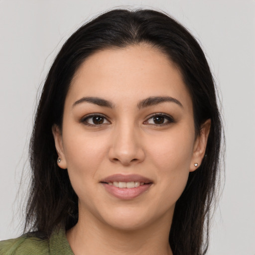 Joyful latino young-adult female with long  brown hair and brown eyes