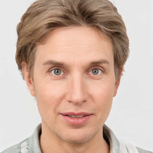 Joyful white adult male with short  brown hair and grey eyes