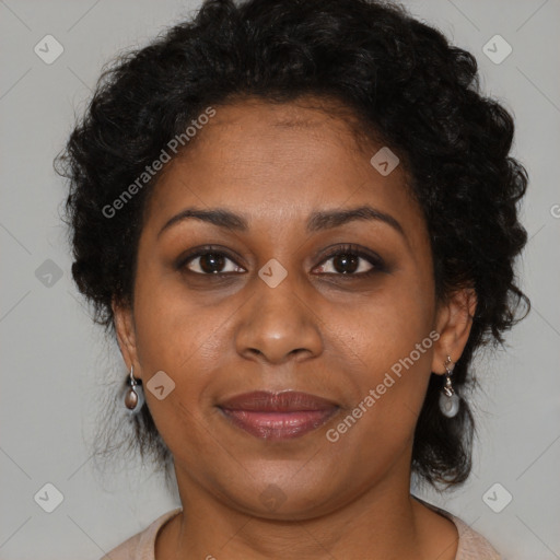 Joyful black adult female with medium  brown hair and brown eyes