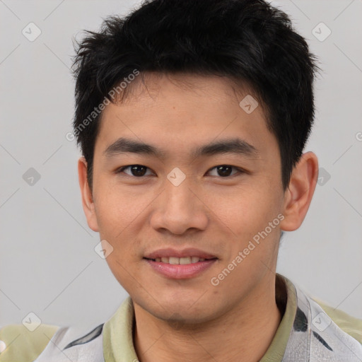 Joyful asian young-adult male with short  brown hair and brown eyes