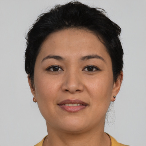 Joyful asian young-adult female with short  brown hair and brown eyes