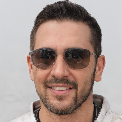 Joyful white adult male with short  brown hair and brown eyes