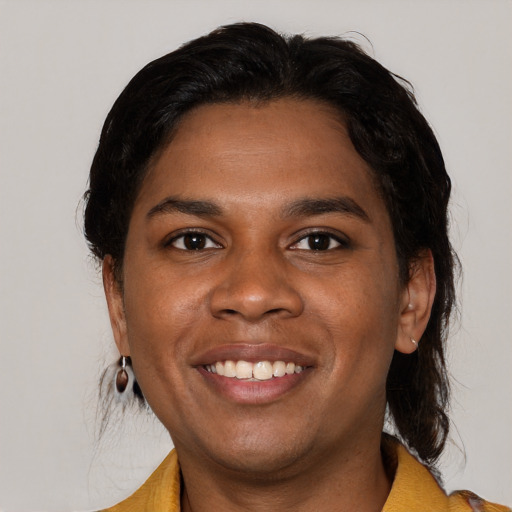Joyful black young-adult female with medium  black hair and brown eyes