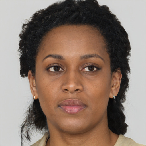 Neutral black adult female with medium  brown hair and brown eyes