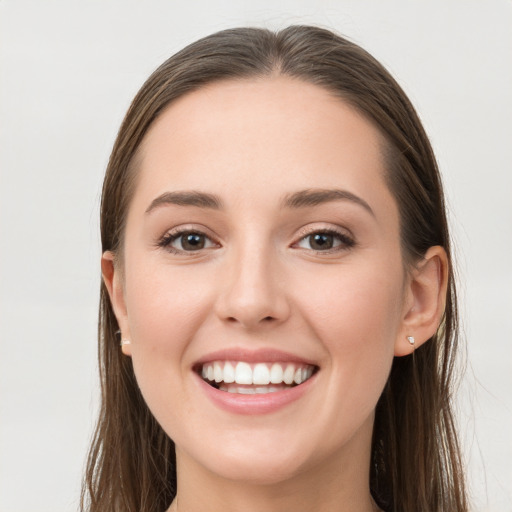 Joyful white young-adult female with long  brown hair and grey eyes