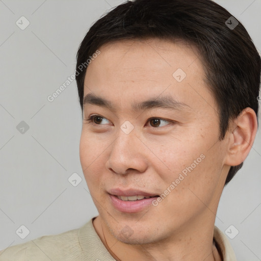 Joyful asian young-adult male with short  brown hair and brown eyes