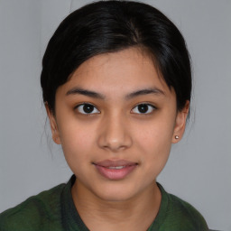 Joyful latino young-adult female with medium  brown hair and brown eyes