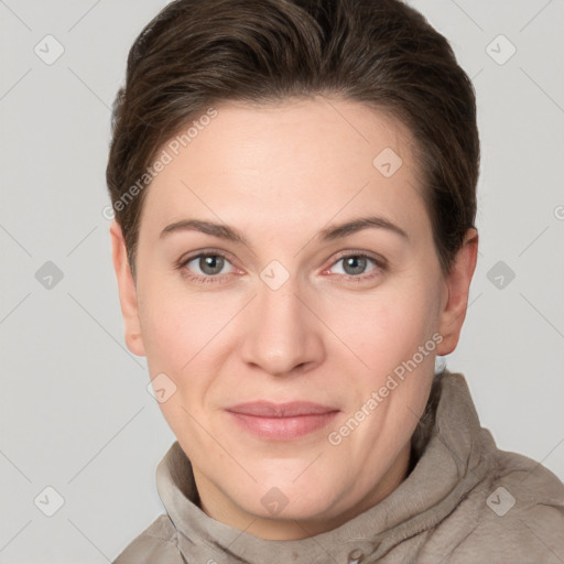 Joyful white young-adult female with short  brown hair and grey eyes